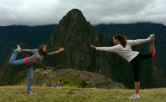 Gianna and Melissa demonstrate a Dancer's Pose at the top of Peru's Machu Picchu